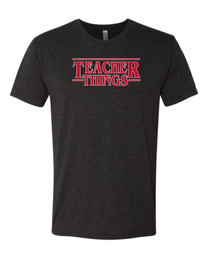 A vintage black triblend t-shirt with a design that is inspired from stranger things that says Teacher Things