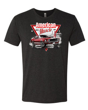 A vintage black t-shirt with the words American Muscle since 1967. The image also features a classic muscle car from 1967 with a gas station in the background.