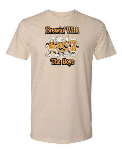 This cream color t-shirt features the words Brewin' with the boys. This design also features four beers having a good time on the design as well.